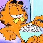 Garfield the cat on sofa with popcorn and remote
