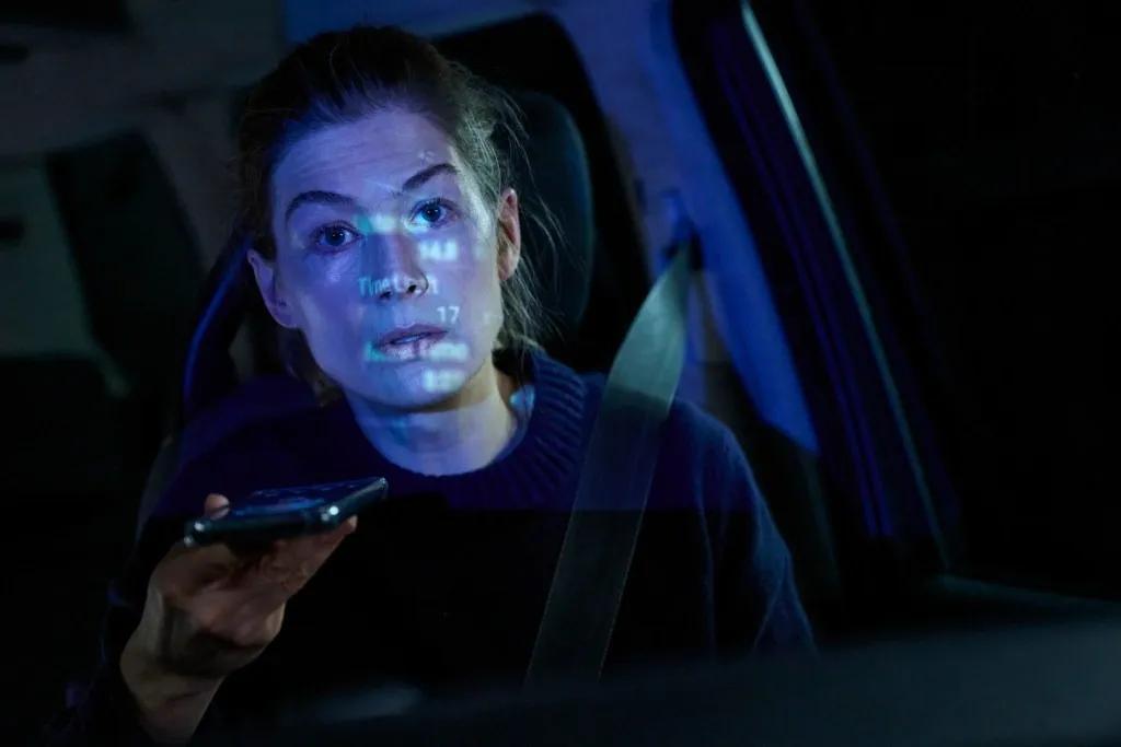 Still from Hallow Road – Maddie (Rosamund Pike) sits in a car passenger seat.