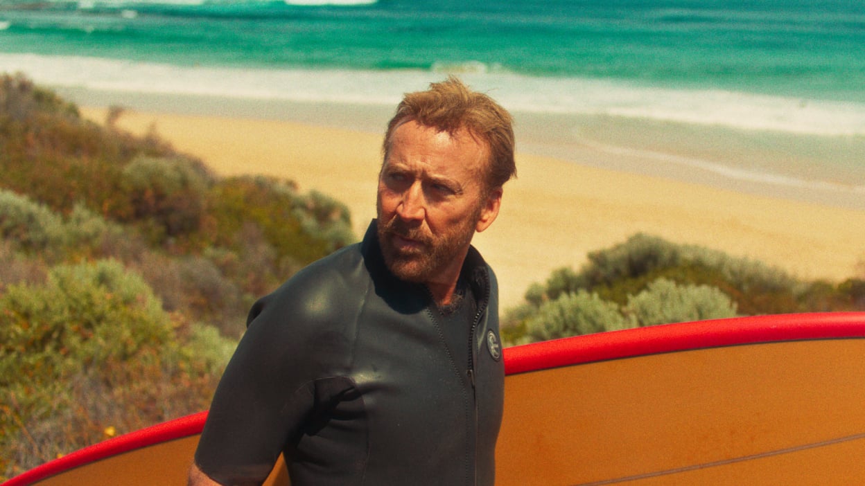 nicolas cage with surfboard in australia for the surfer by lorcan finnegan