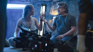 writer and director johannes roberts speaking with johnny sequoyah as lucy on set of primate