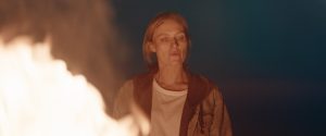 Promotional shot from the 2026 film Redux Redux showing the character of Irene taking fiery vengeance on killer Neville
