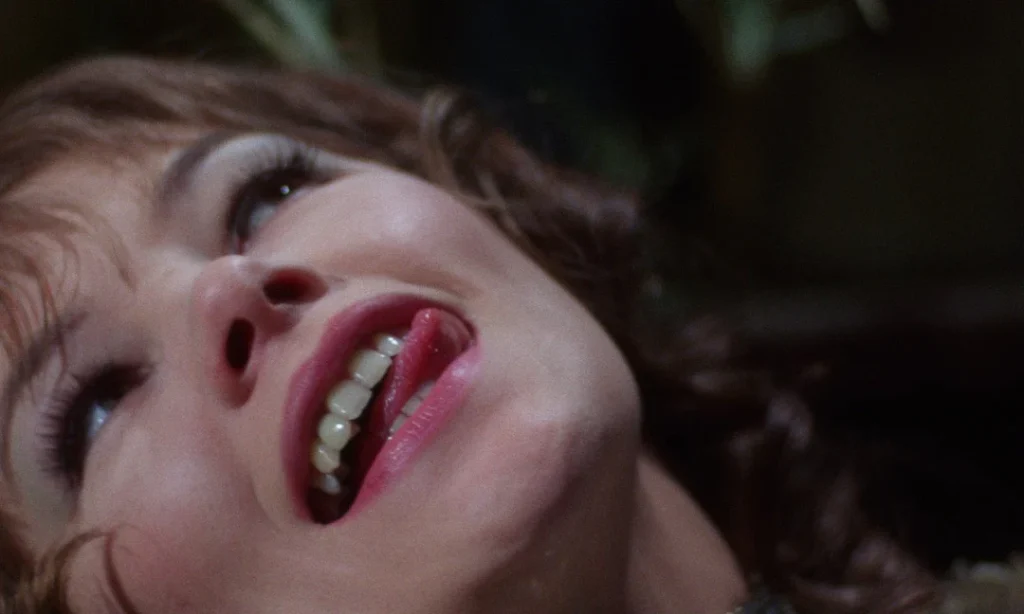 Glenda Jackson as Vivien rolls her eyes and sticks out her tongue