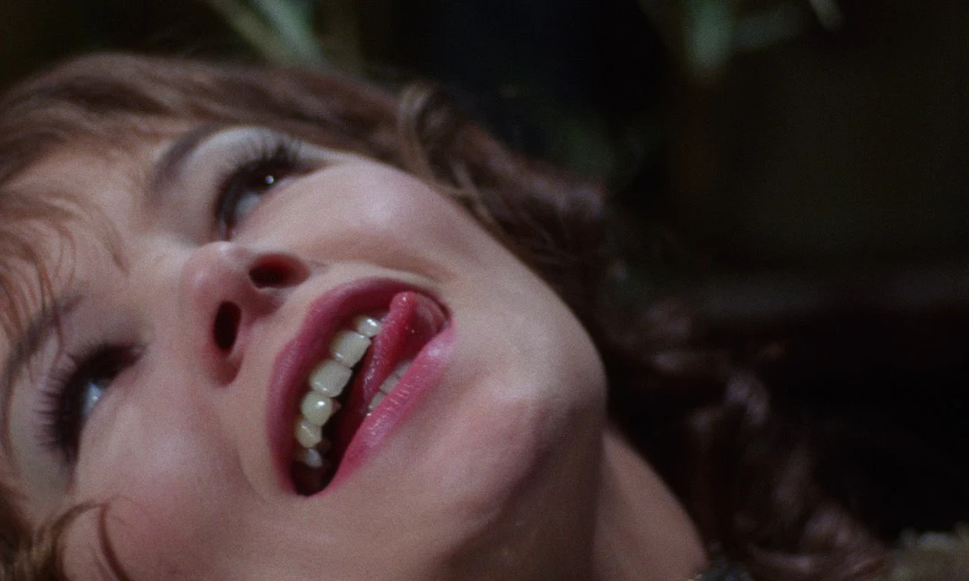 Glenda Jackson as Vivien rolls her eyes and sticks out her tongue